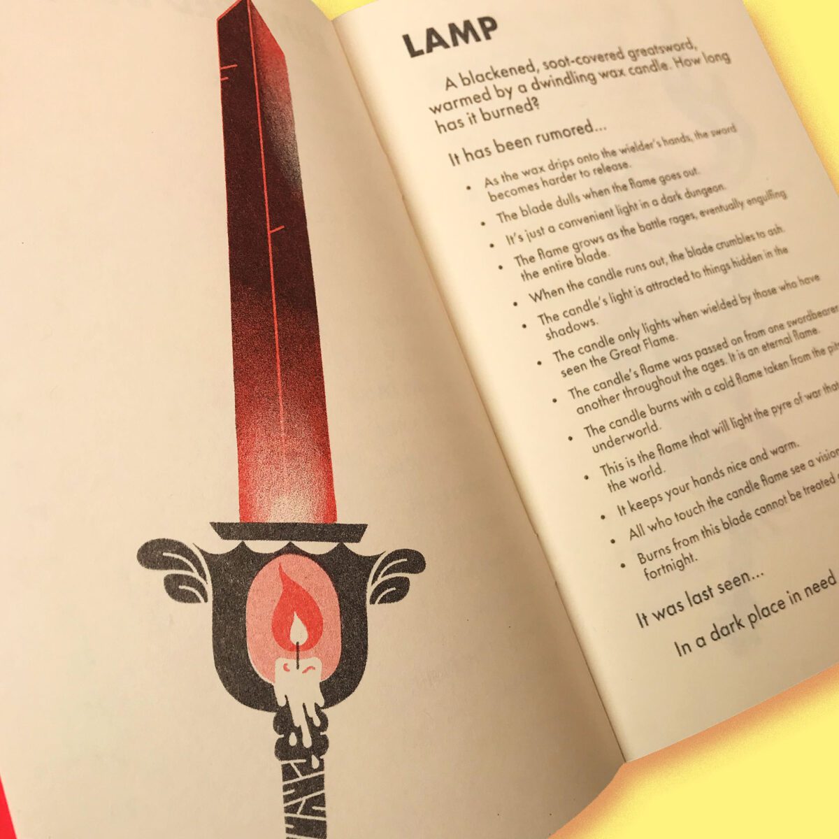 A page from a zine with a print of a sword with a candle in its hilt.