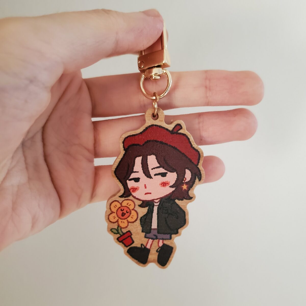 a wood charm of forest, a kid in a red beret with their friend flor, a yellow flower