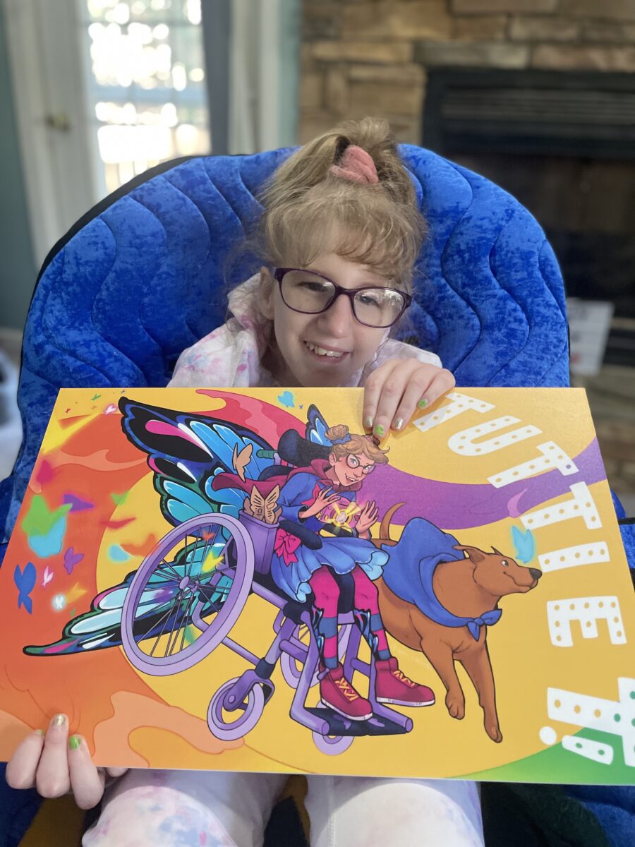 Photo of a child holding a poster of the superhero self they created and was designed by an artist.