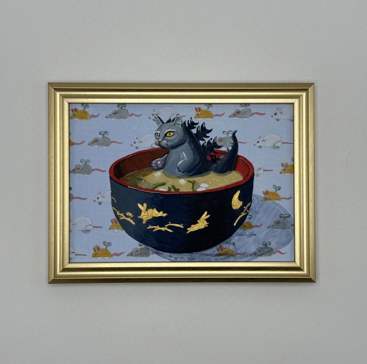 Catzilla walking through a bowl of comforting miso soup. Wind up mouse toys as the patterned background.